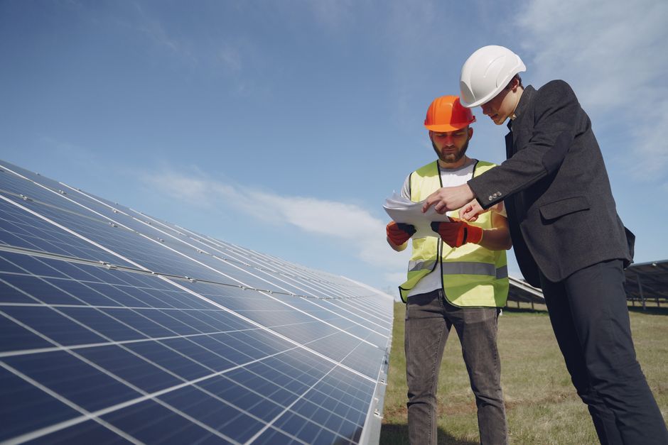 Solar panel technician inspecting a rooftop installation